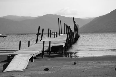 Wooden pier against mountains