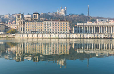 Reflection of buildings on saone river in lyon