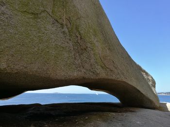 Low angle view of rocks against blue sky