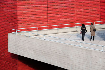 Rear view of women walking on building terrace