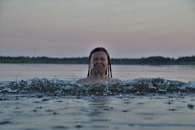 View of girl swimming in lake
