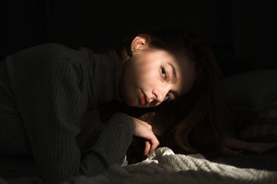 Portrait of woman sitting at home