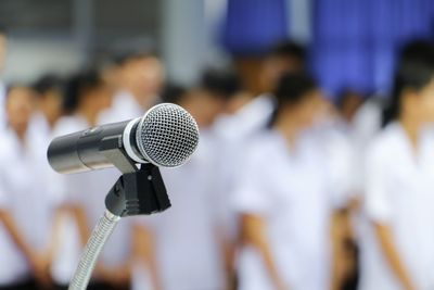 Close-up of microphone against defocused people