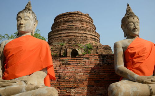 Statue of temple against building