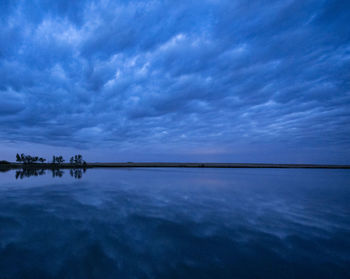 Scenic view of sea against sky at dusk