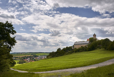 Built structure on landscape against sky