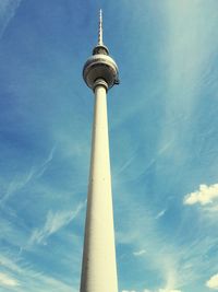 Low angle view of communications tower against sky