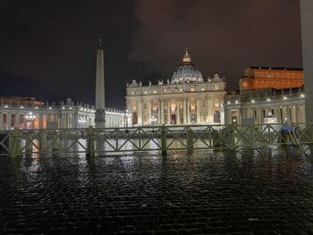 Illuminated building against sky at night