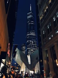 Low angle view of illuminated buildings in city at night