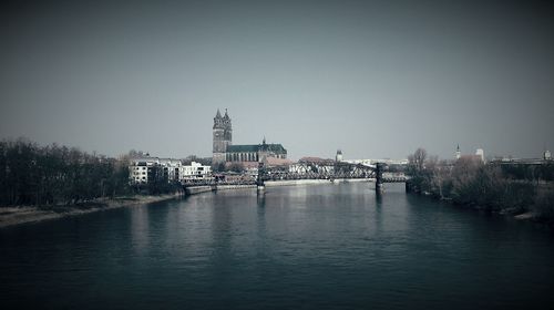 Magdeburg cathedral by elbe river against sky in city