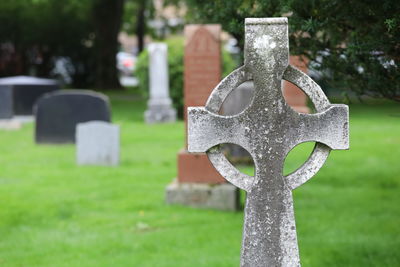 Close-up of cross against stone wall