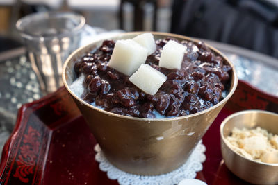 Korean red bean bingsu also called shaved ice placed on a copper bowel.