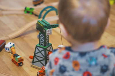 Close-up of boy playing with miniature train at home