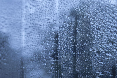 Full frame shot of raindrops on glass window