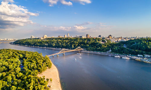 View of bridge over river against cloudy sky