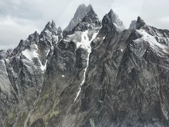 Scenic view of mountains against cloudy sky