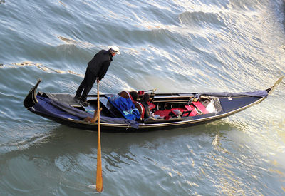 People in boat on sea against sky