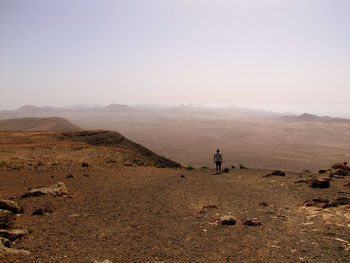 Mid distance of man standing on arid landscape