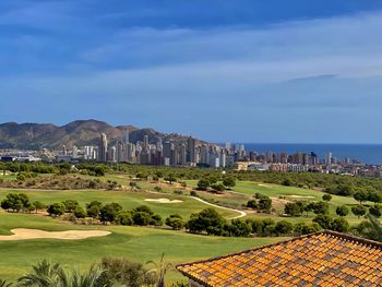 City skyline behind golf course