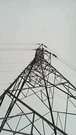 Low angle view of electricity pylon against sky