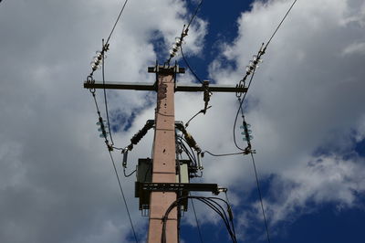 Low angle view of cranes against sky