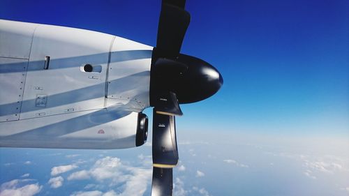 Close-up of airplane propeller against blue sky