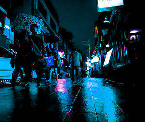 People walking on road at night