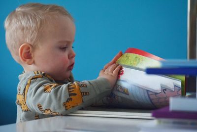 Side view of boy playing with toy car
