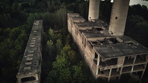 High angle view of old power station amidst trees in forest