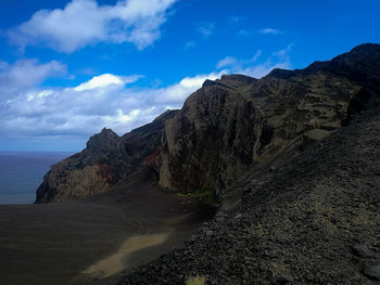 Scenic view of sea and mountains against sky