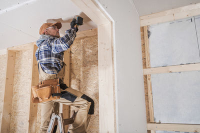 Side view of young man working at home