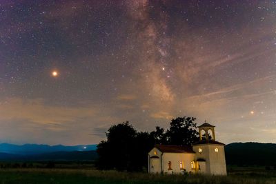 Scenic view of field against sky at night