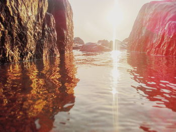 Close-up of water against sky during sunset