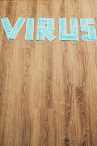 High angle view of text on hardwood floor