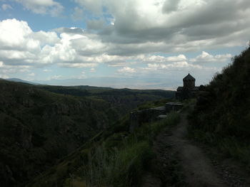 Scenic view of landscape against cloudy sky