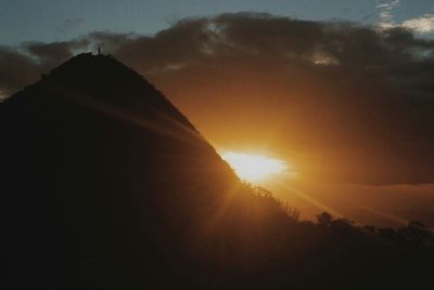 Scenic view of mountains against sky at sunset