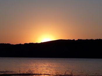 Scenic view of lake against romantic sky at sunset