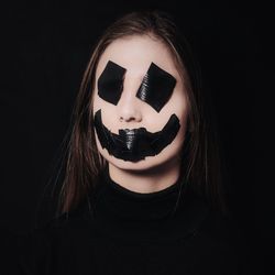 Close-up of human face against black background