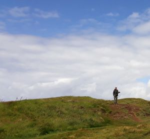 Man on field against sky