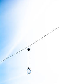 Low angle view of power cables against clear sky