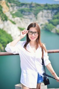 Portrait of smiling young woman standing outdoors