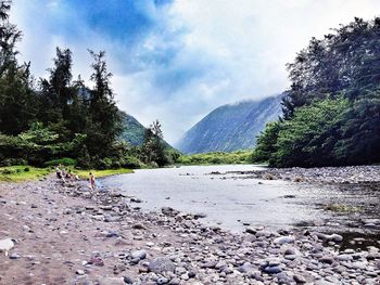 Scenic view of mountains against cloudy sky