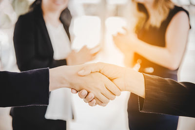 Cropped image of business people shaking hands