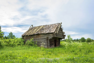 Abandoned building on field against sky