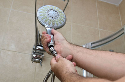 High angle view of man working in bathroom