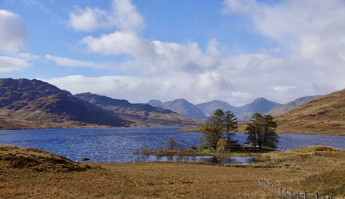 Scenic view of lake and mountains against sky