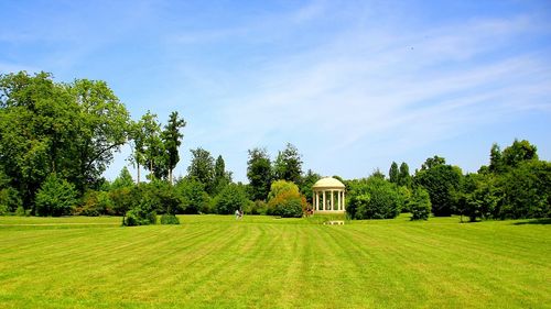 Scenic view of grassy field against cloudy sky