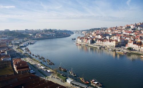 High angle view of townscape by sea against sky