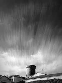 Low angle view of buildings against cloudy sky