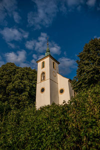 Low angle view of building and trees against sky